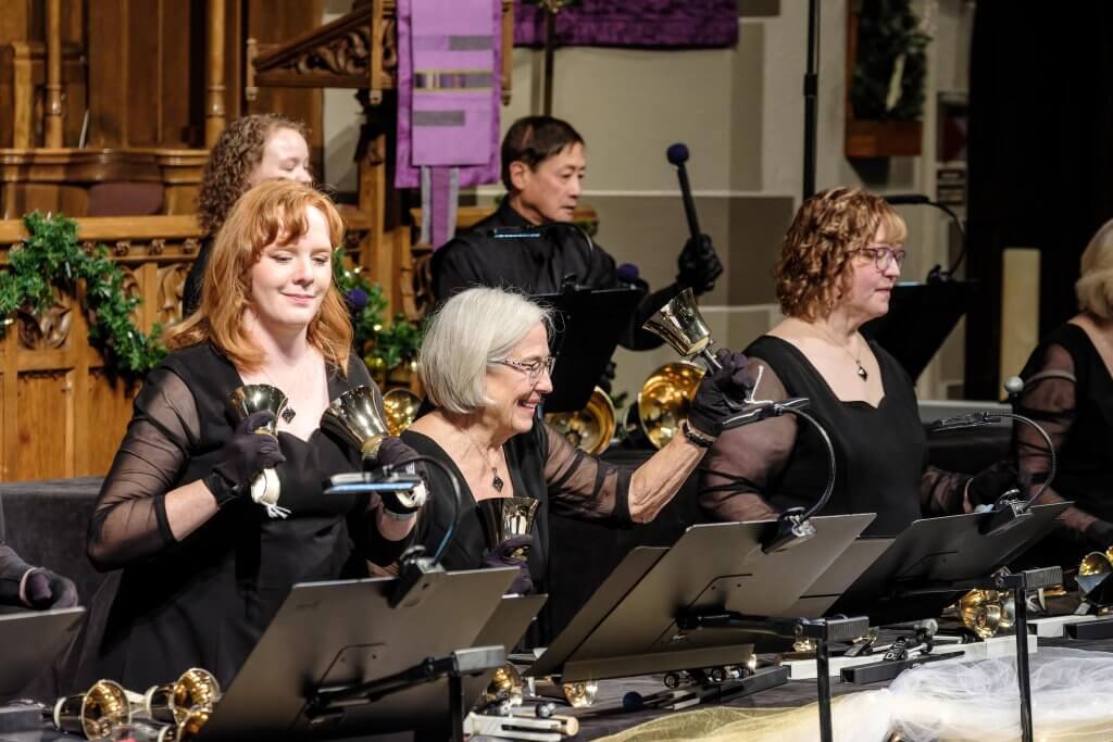 Join us! Kalamazoo Ringers smile happily at their Christmas concert